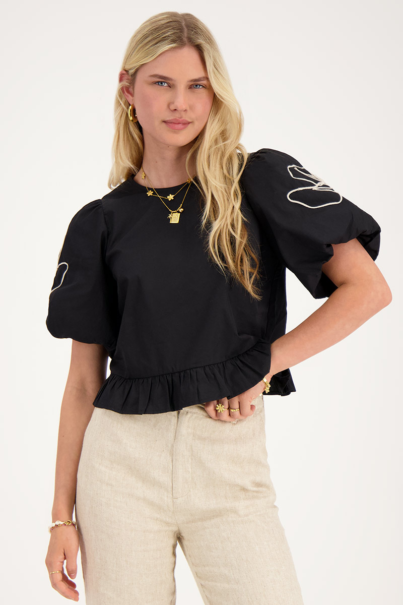 Black blouse with floral detail and bows at back 