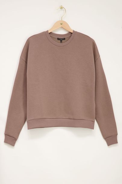 Beige trui met worldtour backprint