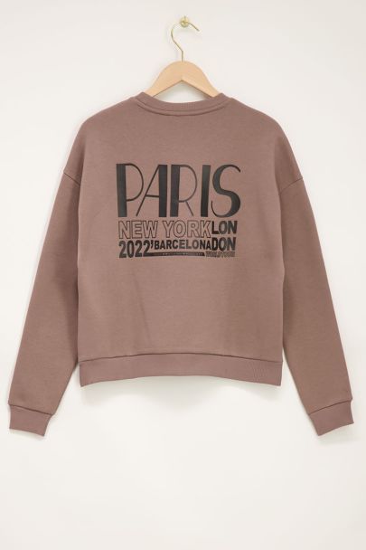 Beige trui met worldtour backprint