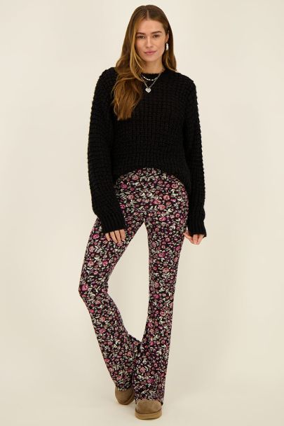 Black flared trousers with red floral print