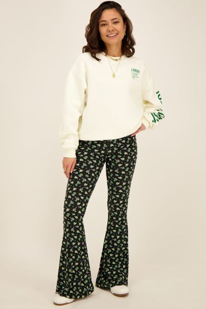 Black flares with green floral print