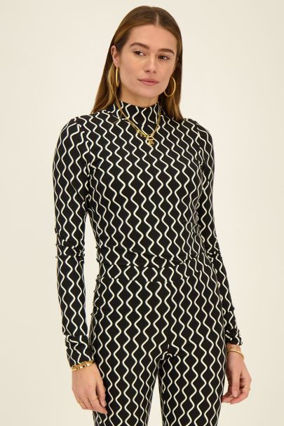 Black turtleneck top with swirl print