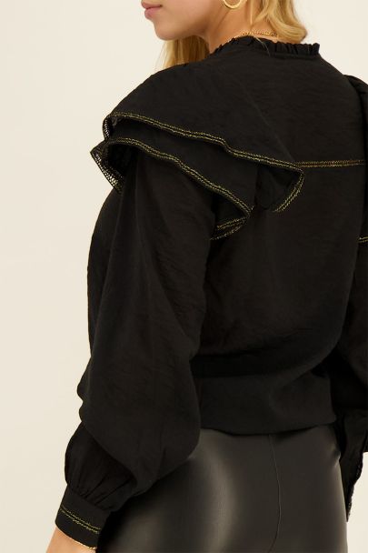 Schwarze Bluse mit Rüschen und goldenem Lurex