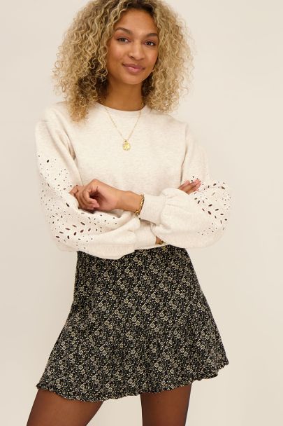 Black ruffled skirt with beige flowers