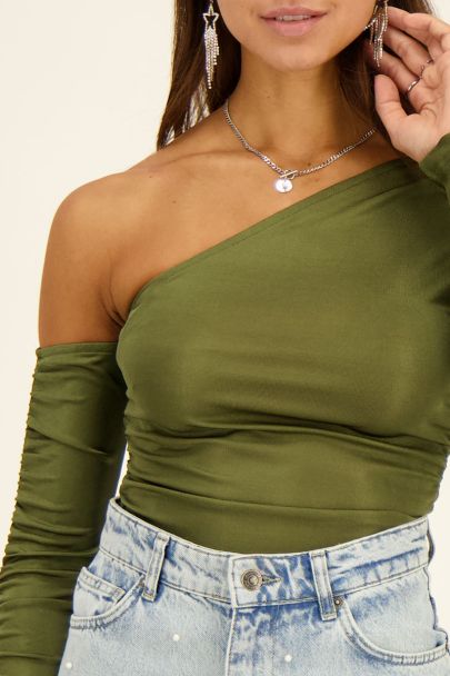 Green one-shoulder draped top with long sleeves