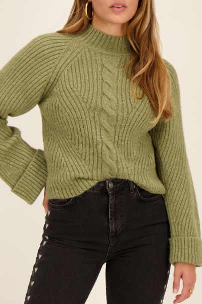 Dark green sweater with rolled sleeves