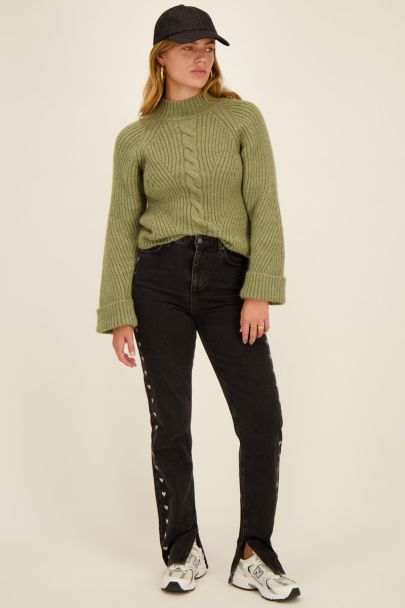 Dark green sweater with rolled sleeves
