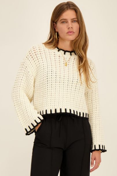 White open knit sweater with black border
