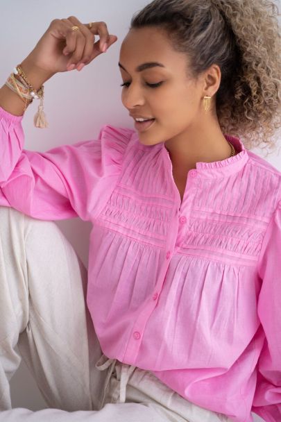 Pink pleated blouse with puff sleeves