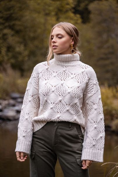 Beige cableknit turtleneck sweater