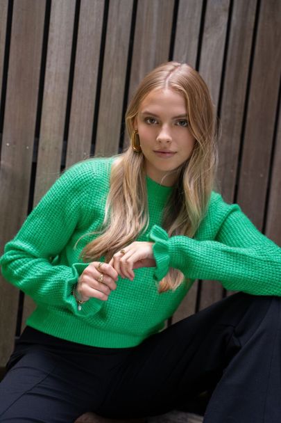 Green sweater with ruffle detail