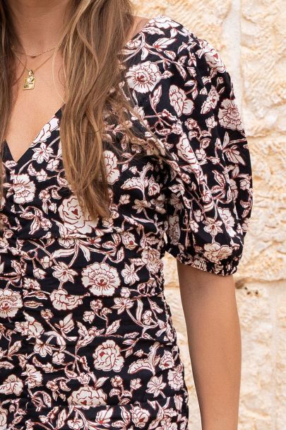 Black v-neck dress with beige floral print