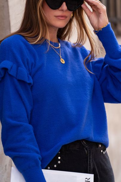 Blue jumper with ruffles