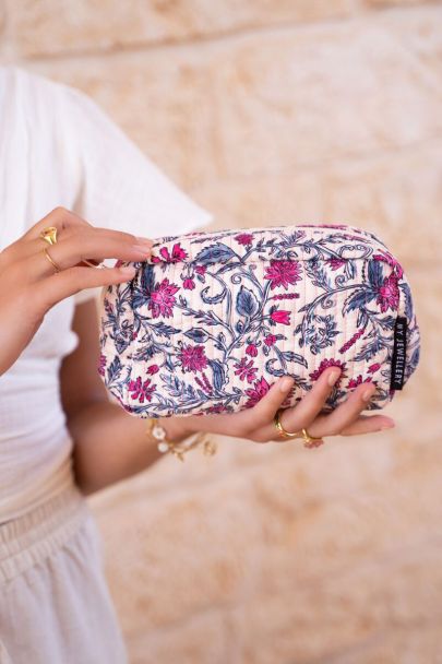 Pale pink toiletry bag with floral print