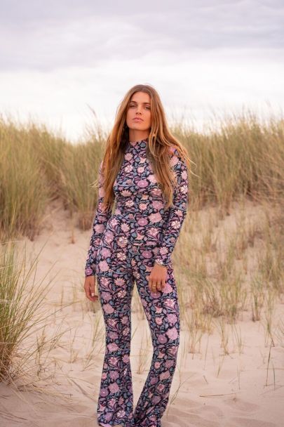 Black turtleneck top with purple floral print