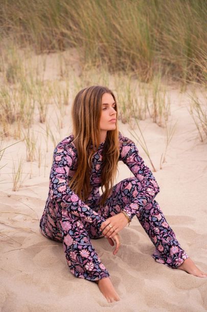 Black turtleneck top with purple floral print