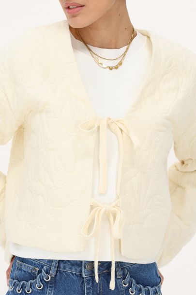 Beige bomber jas
