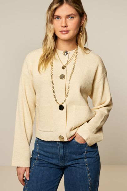 Beige gebreid vest met goudkleurige knopen