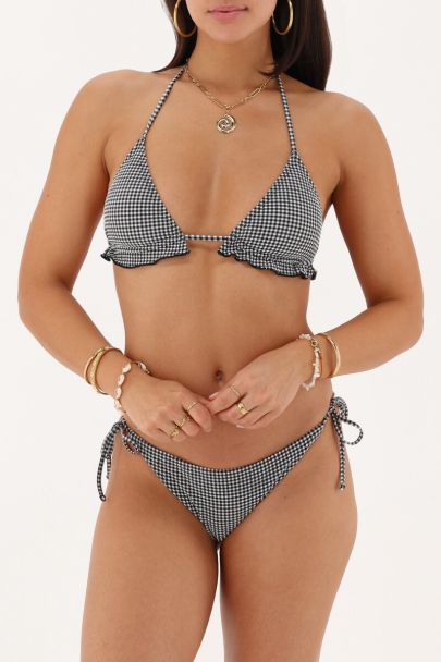 Bas de bikini noir et blanc avec un motif à carreaux et nœud