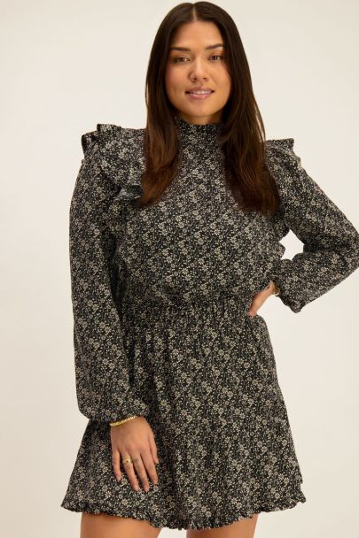 Black ruffled blouse with beige flowers