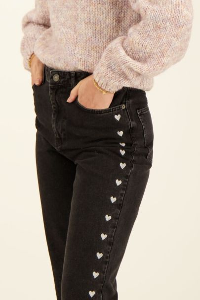 Black split jeans with embroidered hearts