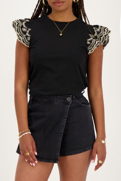 Black top with embroidered sleeves