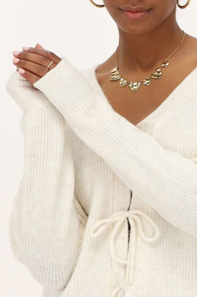 Crème vest met strikjes