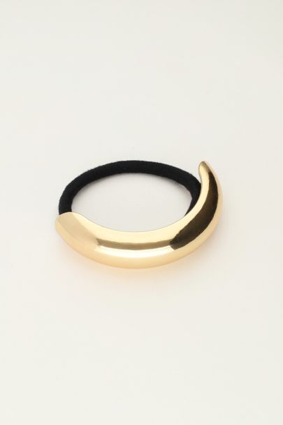 Hair tie with gold coloured curve
