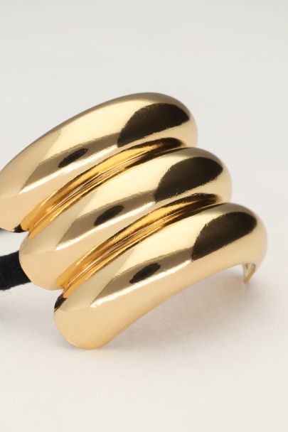 Hair tie with triple gold coloured curve