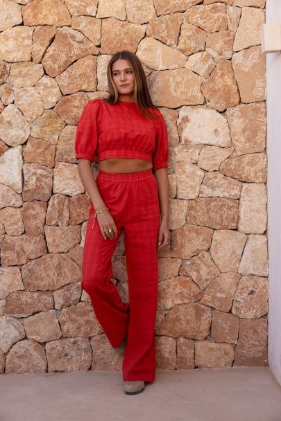Red top with puff sleeves and open back