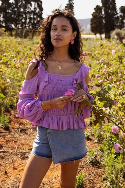 Purple top with long sleeves and ruffles