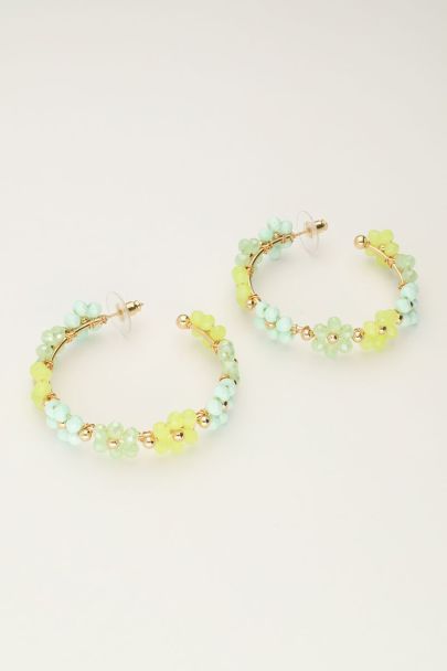 Large hoop earrings with green flowers