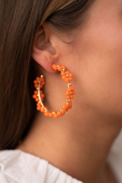 Large hoop earrings with orange flowers