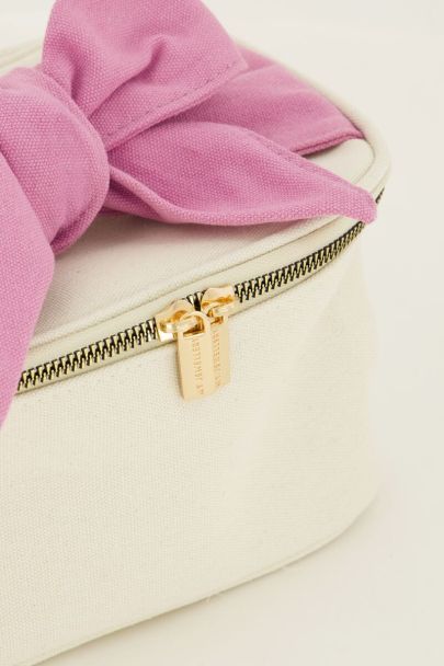 Beige toiletry bag with pink bow
