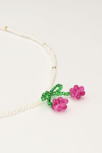 White beaded necklace with cherry