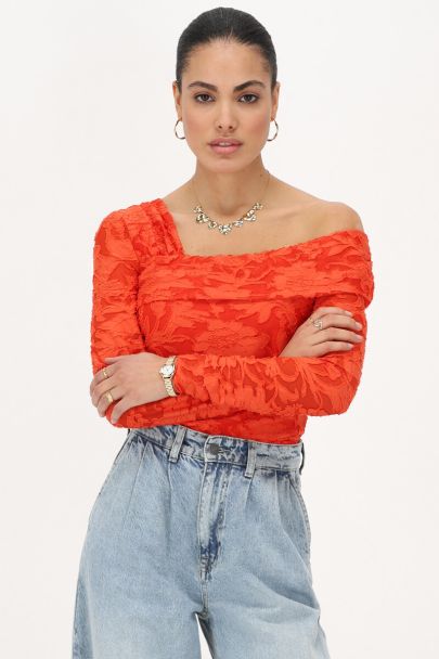 Orange asymmetrical top with flowers