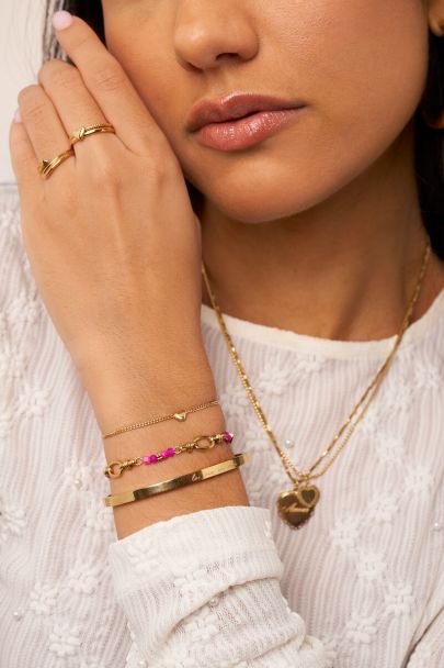 Ovale schakelarmband met roze kralen