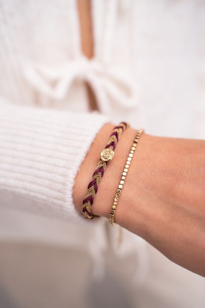 Paarse gevlochten armband met bedel