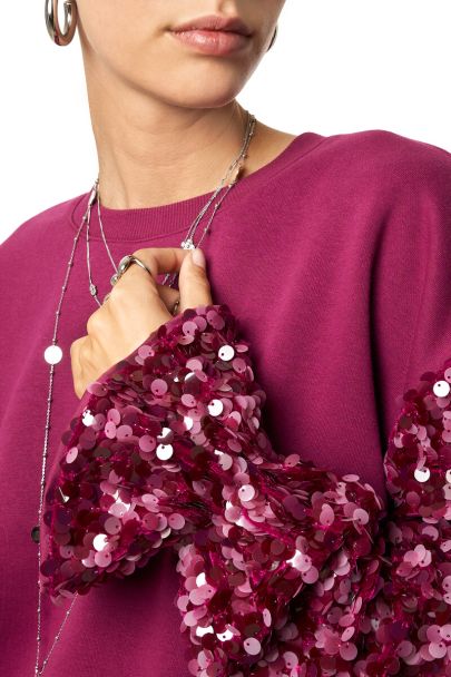 Paarse sweater met pailletten mouwen