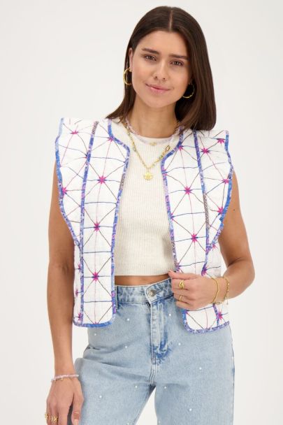 White gilet with blue and pink embroidery