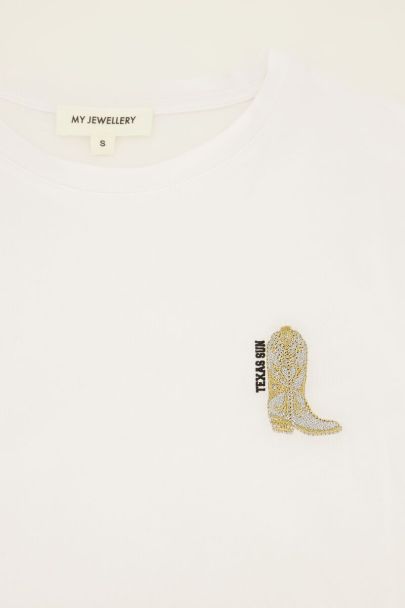 T-shirt blanc avec bottes de cow-boy dorées 