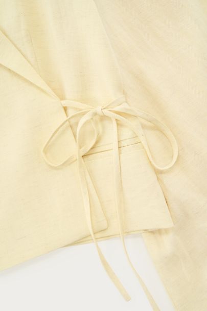 Yellow blazer top with bow detail