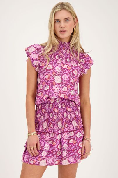 Purple top with pink floral print and smock