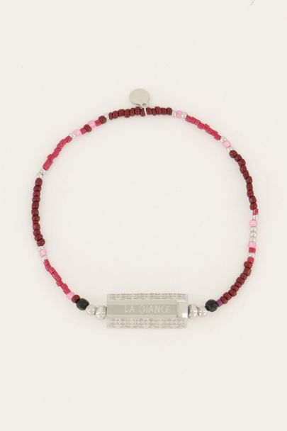 Bracelet avec perles rouges et charm