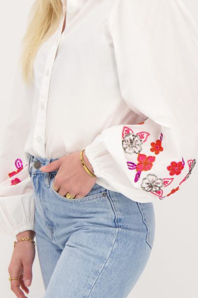 White blouse with pink beaded flowers