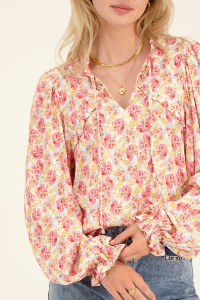 White floral print top with trumpet sleeves