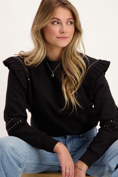 Black ruffled sweater with studs