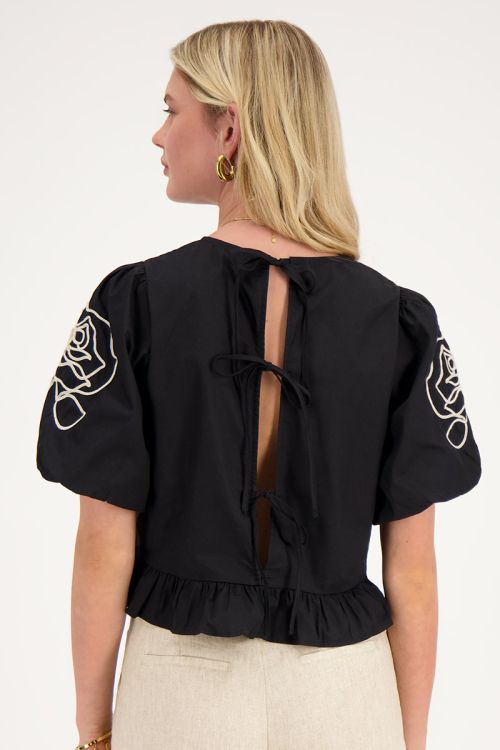 Black blouse with floral detail and bows at back 