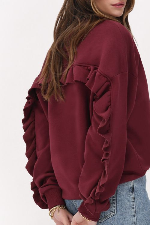 Dark red sweater with ruffle and patch