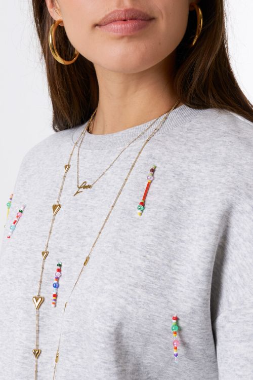 Light grey sweater with coloured beaded fringes | My Jewellery